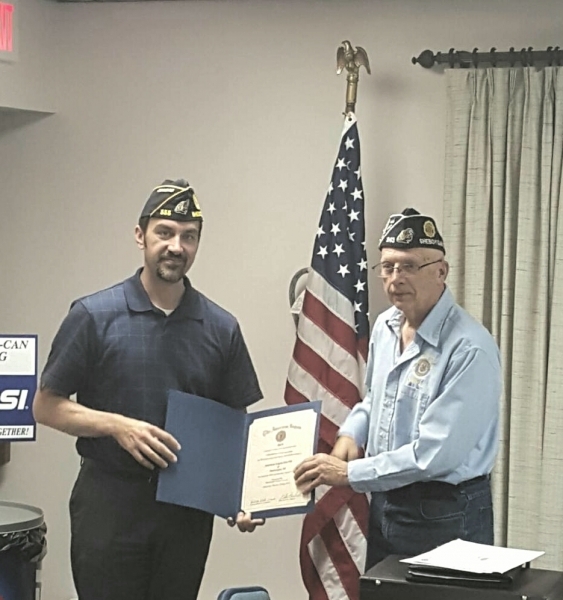 County Commander DuWayne Wieck presents Post 555 Commander Craig Stewart with a certificate recognizing the post achieving 100% membership for 2019.  