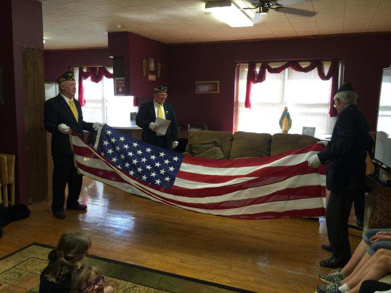 American Legion Post 122 demonstrates the folding of the flag ceremony for St. Wenceslaus School children