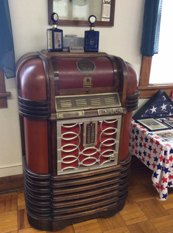 Antique juke box with 75th anniversary whiskey bottles